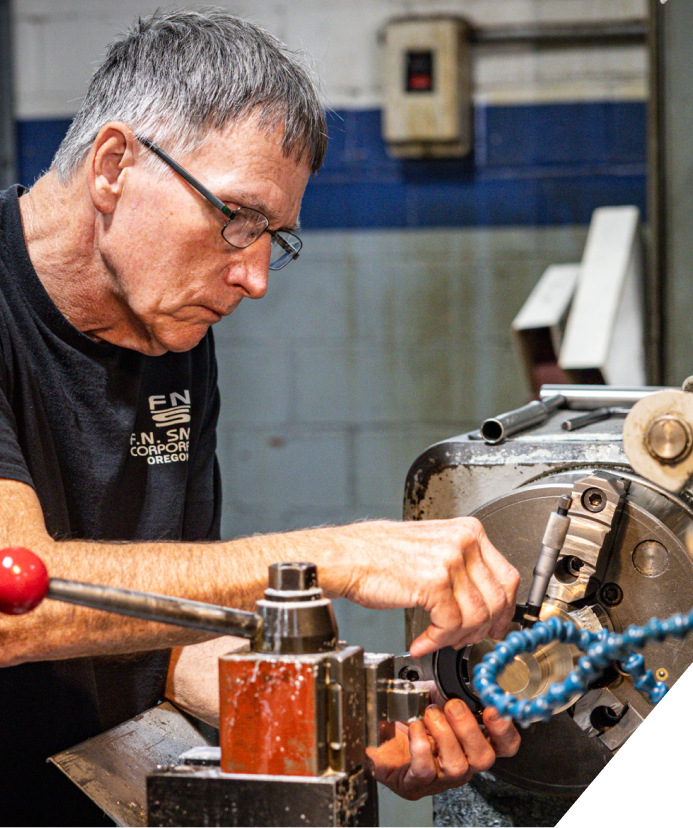 An engineer who is working on a cereal manufacturing machine.