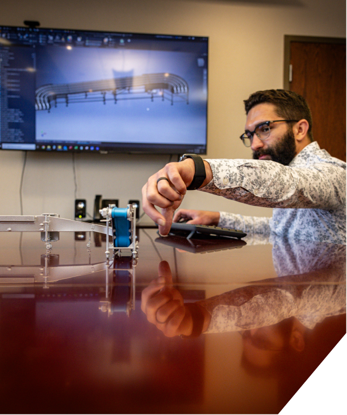 An engineer explaining F.N. Smith conveyor machinery.